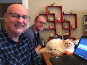 Guys working online with cat